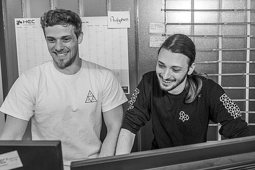 Zwei Personen am PC-Bildschirm, lachen