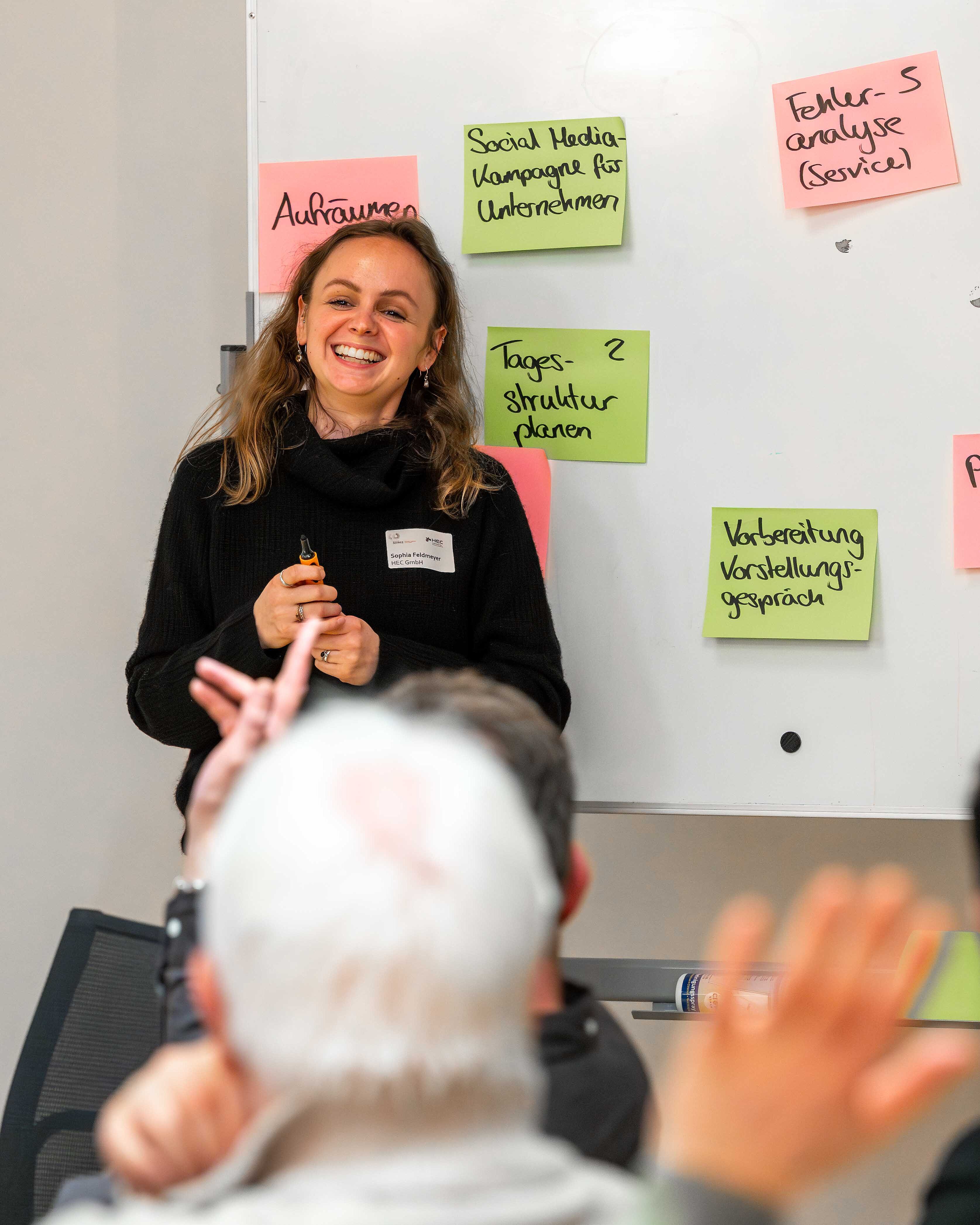 Sophia Feldmeyer klebt Post-its an ein Whiteboard.